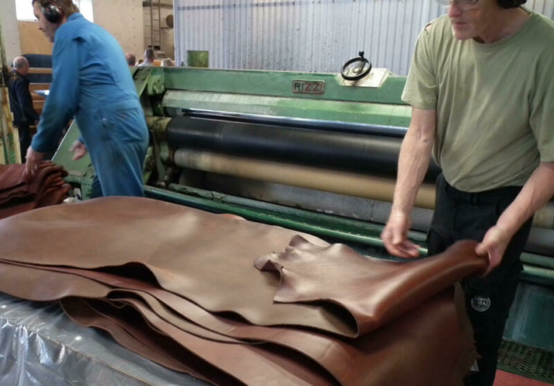 2 Men working with leather.